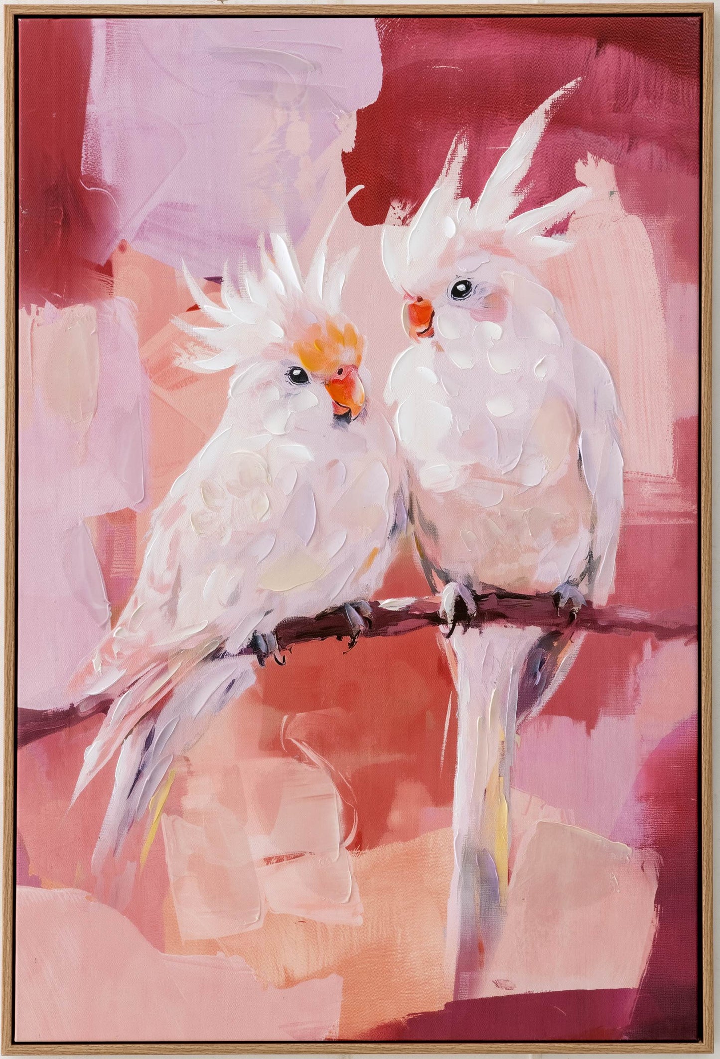 Two cockatoos on a branch against a pink abstract background