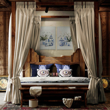Wooden bed with canopy, pillows, and framed artwork in a rustic room.